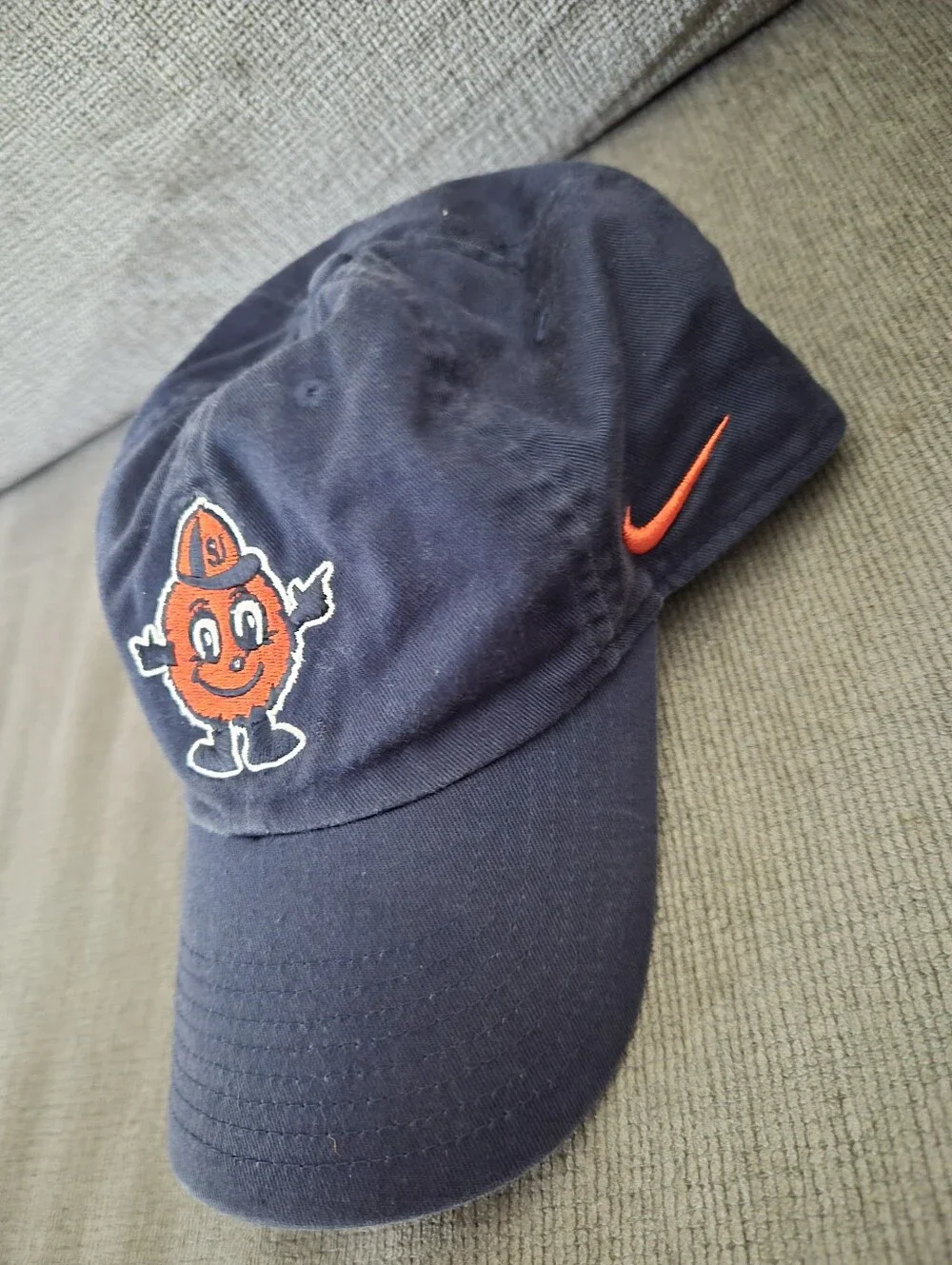 This NIKE Syracuse University Navy Cap with Orange Mascot and Red Swoosh